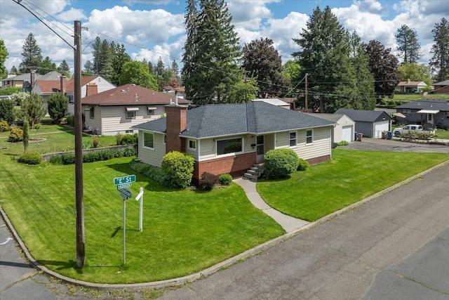 4218 N E St, Spokane, WA 99205 - view of front of property with a residential view, brick siding, a detached garage, and a front yard