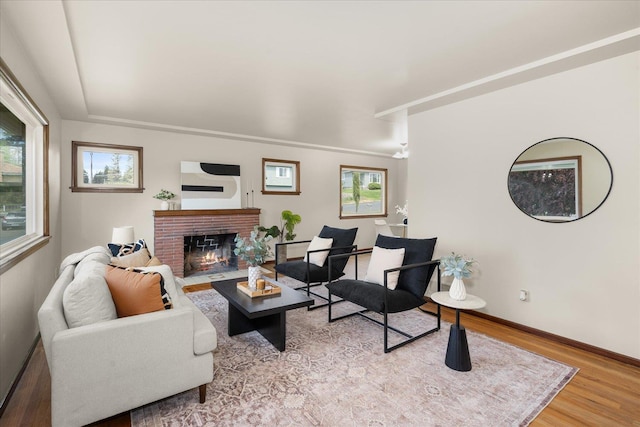 4218 N E St, Spokane, WA 99205 - living area with light wood-type flooring, a brick fireplace, and baseboards
