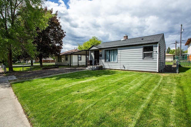 1207 E Bismark Ave, Spokane, WA 99208 - rear view of property with a chimney and roof with shingles