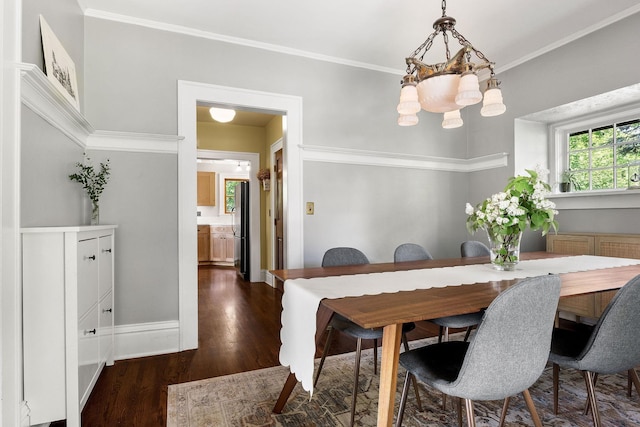 1732 W 14th Ave, Spokane, WA 99204 - dining space with dark wood-style flooring, ornamental molding, a chandelier, and baseboards
