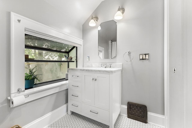 1732 W 14th Ave, Spokane, WA 99204 - bathroom with vanity, tile patterned flooring, baseboards, and vaulted ceiling