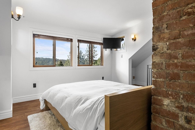 1732 W 14th Ave, Spokane, WA 99204 - bedroom with multiple windows, wood finished floors, and baseboards
