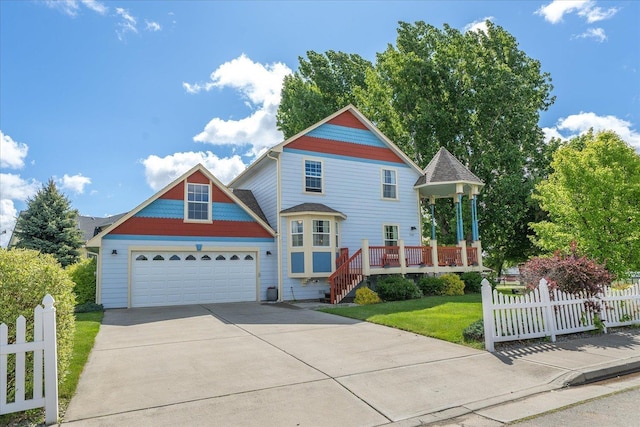 2215 N 8th St, Cheney, WA 99004 - victorian-style house with driveway, a garage, and a wooden deck