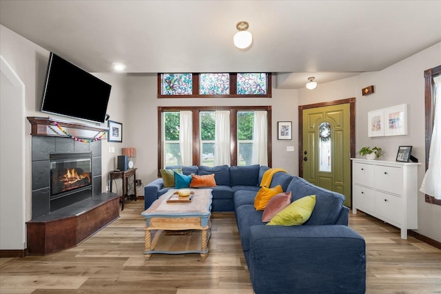2215 N 8th St, Cheney, WA 99004 - living area featuring light wood finished floors, a tiled fireplace, and baseboards