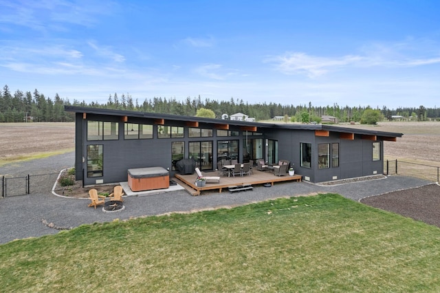 311 N Christensen Rd, Medical Lake, WA 99022 - rear view of house featuring a hot tub, a wooden deck, and an outdoor living space with a fire pit