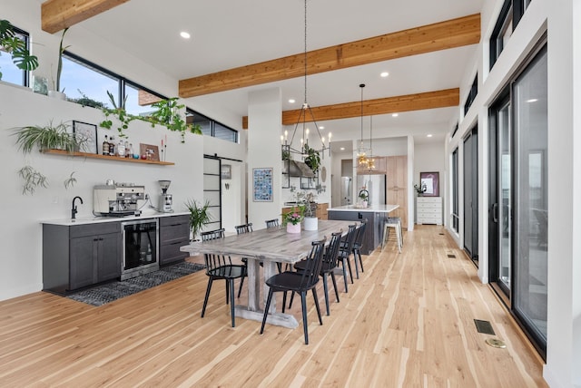 311 N Christensen Rd, Medical Lake, WA 99022 - dining area featuring beverage cooler, a barn door, beamed ceiling, light wood finished floors, and recessed lighting