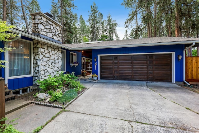 10808 47th Ave, Spokane Valley, WA 99206 - view of front of home featuring stone siding, an attached garage, concrete driveway, and a chimney