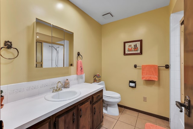 10808 47th Ave, Spokane Valley, WA 99206 - bathroom featuring vanity, toilet, tile patterned floors, baseboards, and a shower