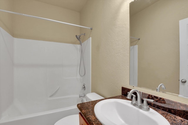216 6th St, Cheney, WA 99004 - full bath featuring toilet, vanity, washtub / shower combination, and a textured wall