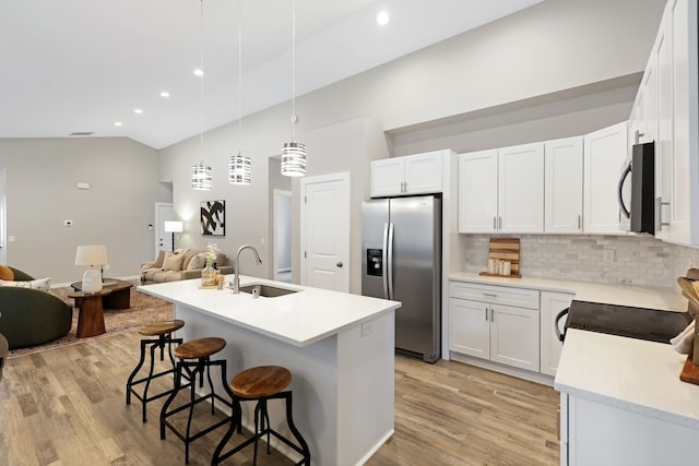 723 S Hatch St, Spokane, WA 99202 - kitchen with stainless steel fridge, black microwave, a sink, open floor plan, and tasteful backsplash