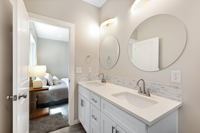 723 S Hatch St, Spokane, WA 99202 - ensuite bathroom with double vanity, decorative backsplash, and wood finished floors
