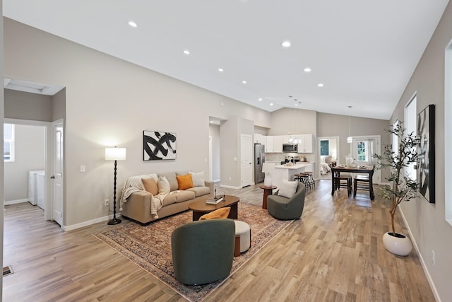 723 S Hatch St, Spokane, WA 99202 - living room featuring light wood-type flooring, baseboards, high vaulted ceiling, recessed lighting, and independent washer and dryer
