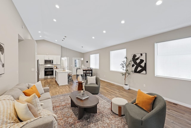 723 S Hatch St, Spokane, WA 99202 - living room with recessed lighting, light wood-type flooring, baseboards, and high vaulted ceiling