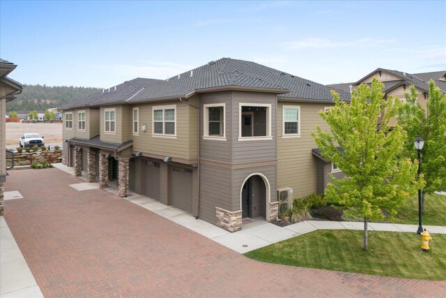 24481 E Pinnacle Ct Unit D, Liberty Lake, WA 99019 - view of front of house featuring a garage, driveway, and stone siding