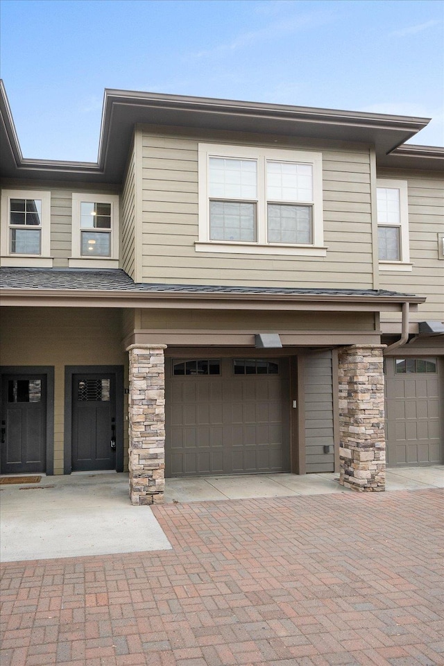 24481 E Pinnacle Ct Unit D, Liberty Lake, WA 99019 - view of front facade featuring an attached garage and decorative driveway