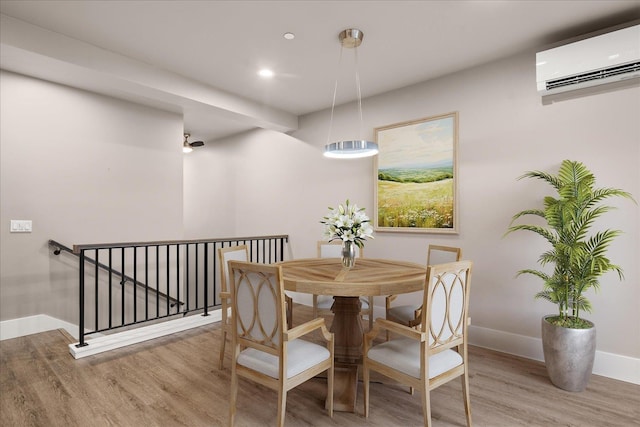 24481 E Pinnacle Ct Unit D, Liberty Lake, WA 99019 - dining area with a wall mounted air conditioner, wood finished floors, baseboards, and recessed lighting