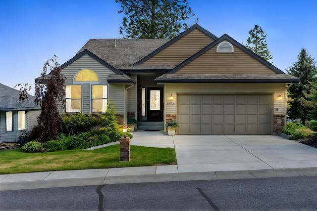 8904 E Boardwalk Ln, Spokane, WA 99212 - view of front of property with an attached garage, concrete driveway, and a front lawn