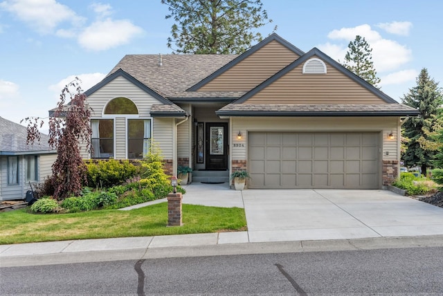8904 E Boardwalk Ln, Spokane, WA 99212 - view of front of property featuring an attached garage, driveway, a front lawn, and a shingled roof