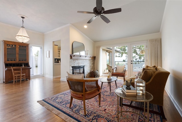 8904 E Boardwalk Ln, Spokane, WA 99212 - living room with healthy amount of natural light, wood finished floors, a fireplace, french doors, and crown molding