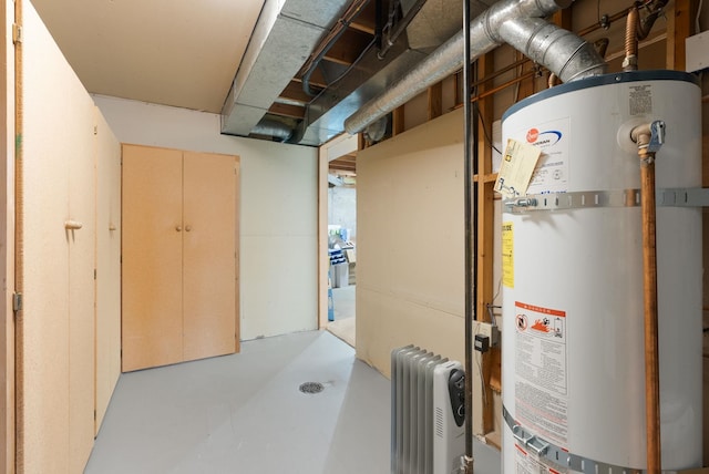 8904 E Boardwalk Ln, Spokane, WA 99212 - utility room featuring water heater and radiator heating unit