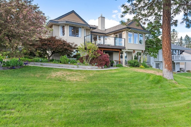 8904 E Boardwalk Ln, Spokane, WA 99212 - view of front of house featuring a chimney, a front yard, and a balcony
