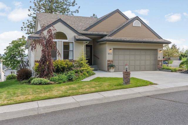 8904 E Boardwalk Ln, Spokane, WA 99212 - view of front of property featuring a garage, driveway, a front yard, and a shingled roof
