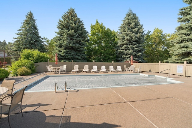 8904 E Boardwalk Ln, Spokane, WA 99212 - view of swimming pool with a patio and view of wooded area