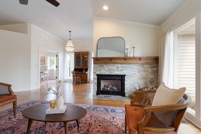 8904 E Boardwalk Ln, Spokane, WA 99212 - living area with ornamental molding, ceiling fan, light wood finished floors, a fireplace, and recessed lighting