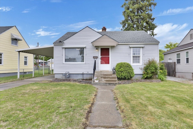 1419 E Glass Ave, Spokane, WA 99207 - view of front of house featuring concrete driveway, an attached carport, a chimney, and a shingled roof