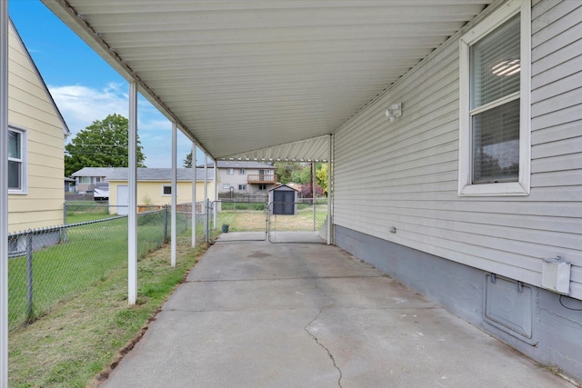 1419 E Glass Ave, Spokane, WA 99207 - view of patio with an attached carport, a gate, and a shed