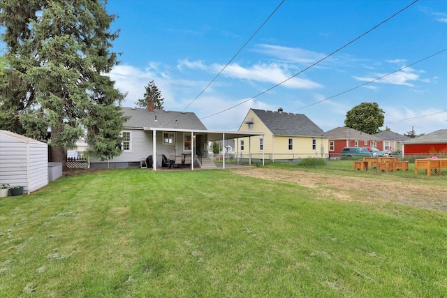 1419 E Glass Ave, Spokane, WA 99207 - rear view of house with a chimney, an outdoor structure, and a patio area