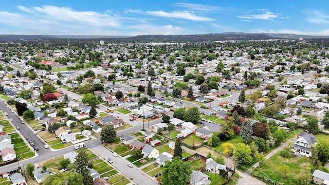 1419 E Glass Ave, Spokane, WA 99207 - aerial view of property's location with a mountainous background and nearby suburban area