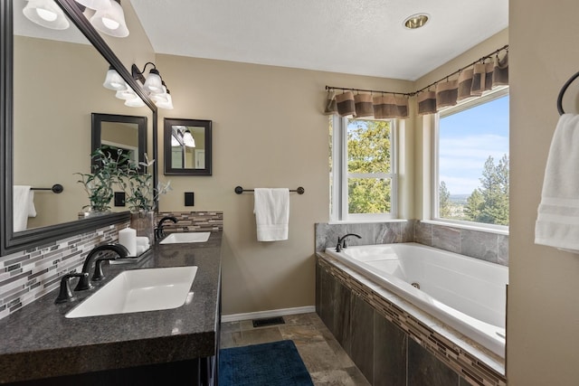 14716 E 48th Ln, Veradale, WA 99037 - full bathroom with backsplash, a jetted tub, double vanity, and baseboards