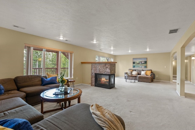 14716 E 48th Ln, Veradale, WA 99037 - carpeted living area featuring a tile fireplace, baseboards, and a textured ceiling