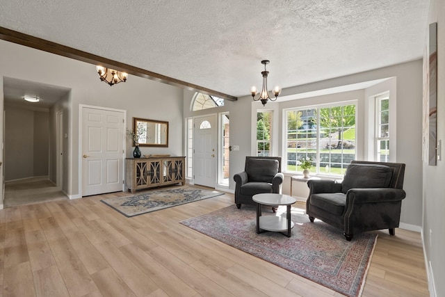 14716 E 48th Ln, Veradale, WA 99037 - sitting room featuring a chandelier, a textured ceiling, light wood-type flooring, and baseboards