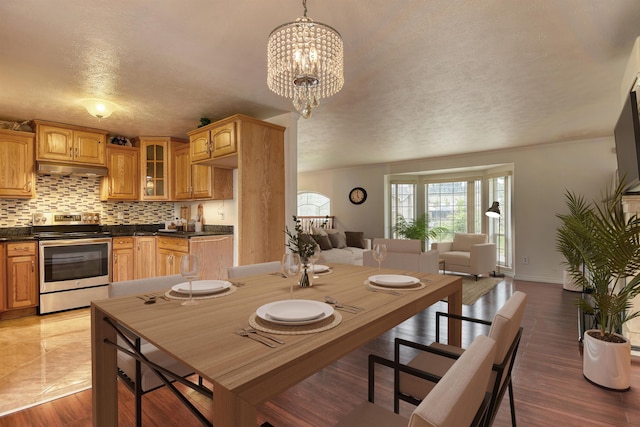 11920 E Railroad Ave, Spokane, WA 99206 - dining space with a textured ceiling, baseboards, and a chandelier