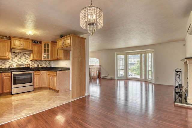 11920 E Railroad Ave, Spokane, WA 99206 - kitchen featuring stainless steel electric stove, open floor plan, dark countertops, glass insert cabinets, and a baseboard radiator