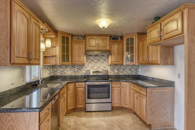 11920 E Railroad Ave, Spokane, WA 99206 - kitchen with appliances with stainless steel finishes, a sink, extractor fan, dark stone counters, and backsplash