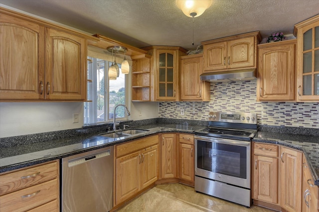 11920 E Railroad Ave, Spokane, WA 99206 - kitchen with appliances with stainless steel finishes, under cabinet range hood, a sink, a textured ceiling, and glass insert cabinets