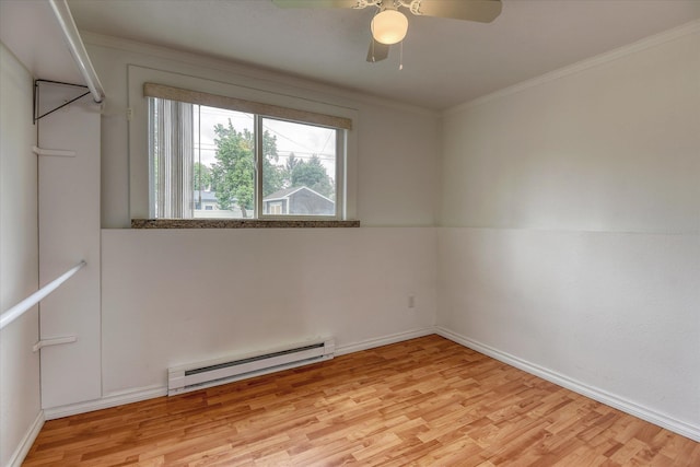11920 E Railroad Ave, Spokane, WA 99206 - spare room with a baseboard radiator, wood finished floors, ceiling fan, baseboards, and crown molding