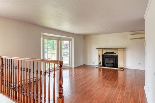 11920 E Railroad Ave, Spokane, WA 99206 - unfurnished living room with a wall mounted AC, wood finished floors, baseboards, and ornamental molding
