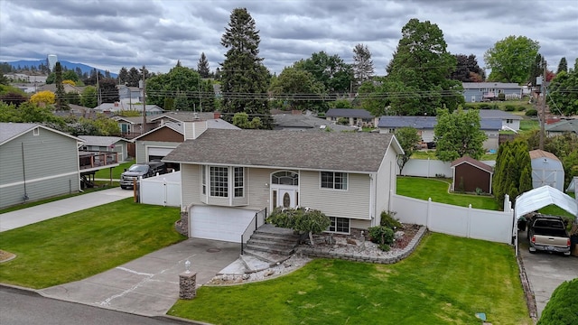 11920 E Railroad Ave, Spokane, WA 99206 - view of front facade featuring driveway, an attached garage, a residential view, and roof with shingles