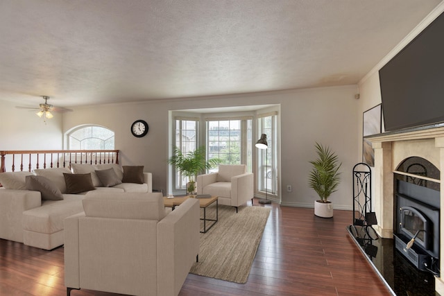 11920 E Railroad Ave, Spokane, WA 99206 - living area featuring dark wood-style flooring, a ceiling fan, a textured ceiling, ornamental molding, and baseboards