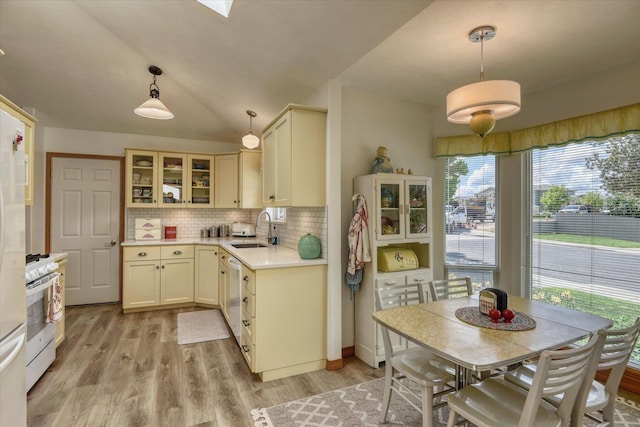 4307 S Apollo St, Spokane, WA 99223 - kitchen featuring white range with gas cooktop, a sink, light countertops, backsplash, and glass insert cabinets