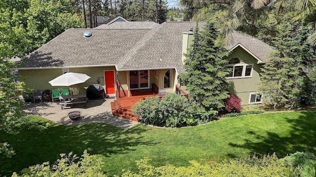 4307 S Apollo St, Spokane, WA 99223 - rear view of property with a chimney, a lawn, roof with shingles, and a deck
