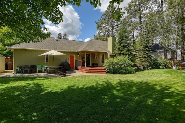 4307 S Apollo St, Spokane, WA 99223 - back of house with an outdoor fire pit, a chimney, a wooden deck, a patio, and roof with shingles
