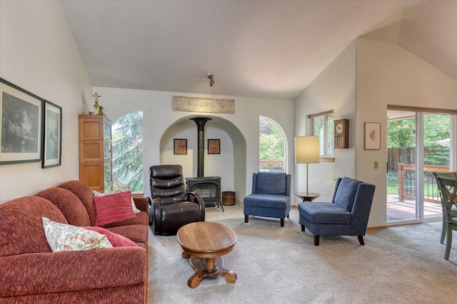 4307 S Apollo St, Spokane, WA 99223 - living area with a wood stove, vaulted ceiling, and light colored carpet