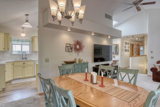 4307 S Apollo St, Spokane, WA 99223 - dining space featuring a ceiling fan, light wood-type flooring, a chandelier, and high vaulted ceiling