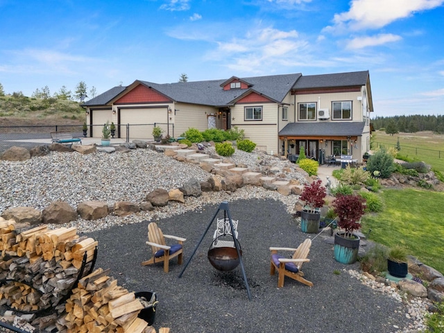 14410 W Jacobs Rd, Spokane, WA 99224 - view of front facade featuring a fire pit, an attached garage, and a patio