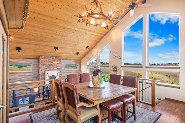14410 W Jacobs Rd, Spokane, WA 99224 - dining space with wood ceiling, a chandelier, high vaulted ceiling, wooden walls, and wood finished floors
